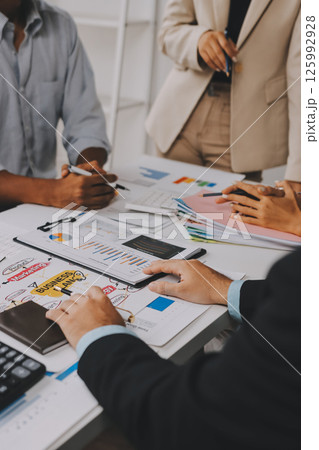 Team of financial advisory services. Asian advisor showing plan of investment to clients in the consultancy office. Team of financial advisory services. Asian advisor showing plan of investment to clients in the consultancy office. 125992928