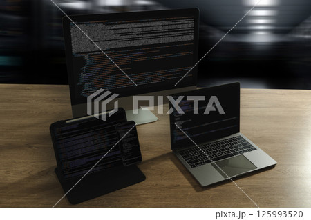 Programming workspace with code on desktop, laptop, tablet, and smartphone. Modern coding, software development, technology, IT office, web design, digital workspace. 125993520