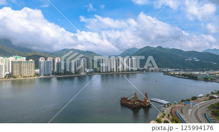 Scenic View of Waterfront City with Mountains and Bright Sky May 4 2025 125994176
