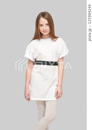 Caucasian young female child in white t-shirt and leggings posing confidently Caucasian young female child in white t-shirt and leggings posing confidently 125994244