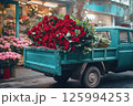 Vintage truck with vibrant red roses near flower market. Flower delivery, Valentines Day, weddings, business promotions for florists, blog post, flower delivery, advertisements. 125994253