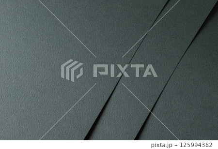 Paper texture with dark green tone, layered sheet and geometric line overlay, clean matte surface Paper texture with dark green tone, layered sheet and geometric line overlay, clean matte surface 125994382