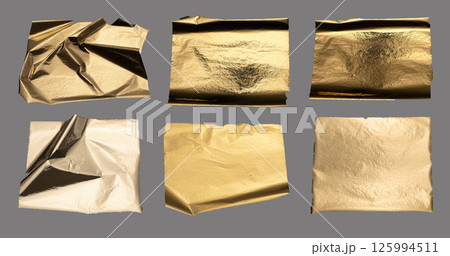Torn and crumpled metallic foil with textured surface, golden and bronze tones, edgy jagged edges, 125994511