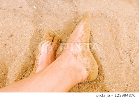 Male feet in the sand on the beach. Beach holiday. Mediterranean, azure sea.Turkey. 125994870