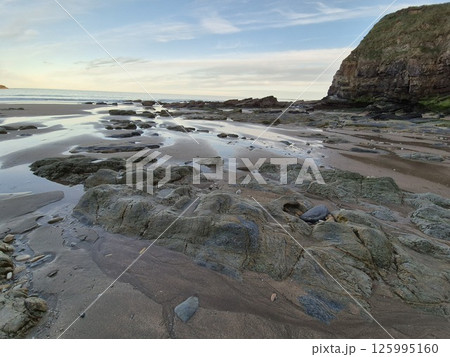 Coastal Water Landscape with Clouds and Beach 125995160
