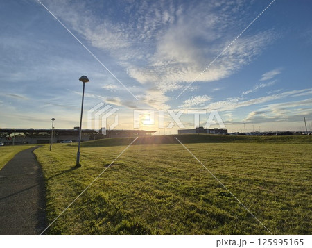 Sunrise over Agricultural Landscape with Grass and Clouds 125995165