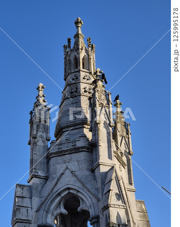 Medieval Architecture Tower with Sculpture and Steeple 125995178
