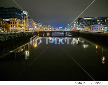 Cityscape at Dusk with Waterway and Bridge 125995459