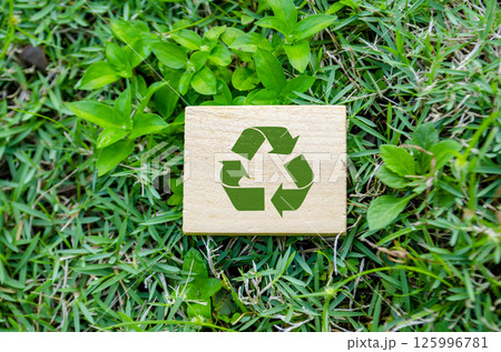 Top view of Recycle symbol on wooden block. Top view of Recycle symbol on wooden block. 125996781