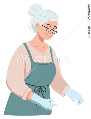 Senior woman in peach shirt and teal apron Senior woman in peach shirt and teal apron 125998894