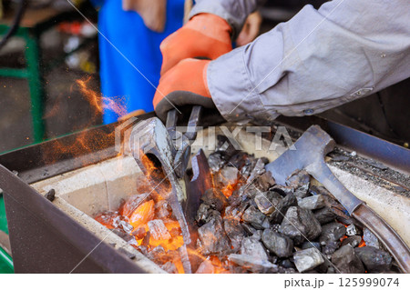 Craftsman works diligently at forge, shaping...の写真素材 [125999074] - PIXTA