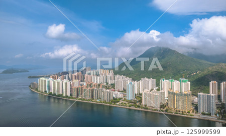 Waterfront Cityscape with High Rise Buildings and a Mountainous Backdrop May 4 2025 125999599