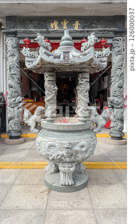 Cultural details of Armenian street in george town penang with intricate stone carvings and incense burner 126000037