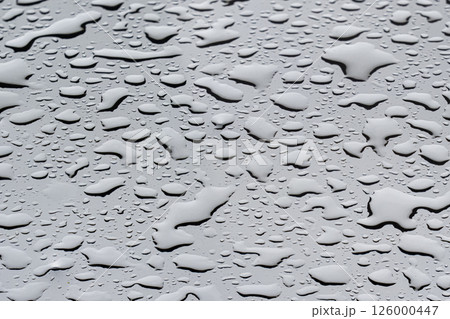 Raindrops Background texture on glass create a captivating gray background in a tranquil setting during a rainy day 126000447