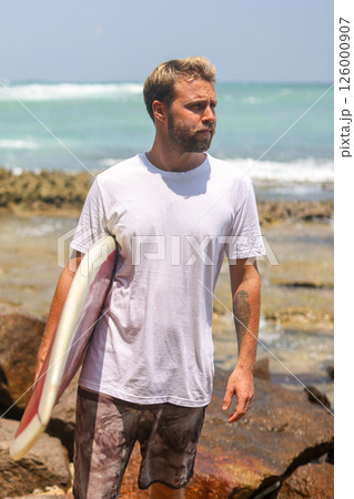 A Surfer at Rocky Beach, fully prepared and eager for an exciting adventure awaits 126000907