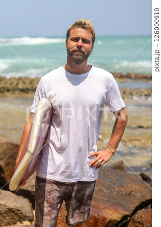 A Surfer at Rocky Beach, fully prepared and eager for an exciting adventure awaits 126000910