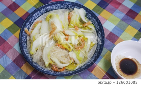close up of Cantonese homemade dish- stir fried dried shrimp,  napa cabbage and  intertwined with translucent glass noodles with soy sauce on the side 126001085