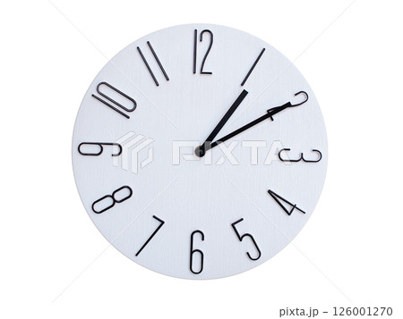 Minimalist Round Wall Clock Showing 01:10 or 13:10. Thin Black Numerals on White Wood Background. 126001270
