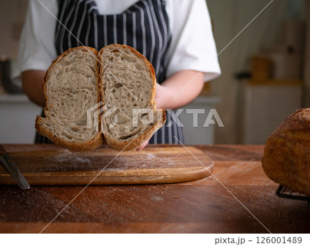 Artisan Sourdough Bread in Hand - Fresh from the Oven. 126001489
