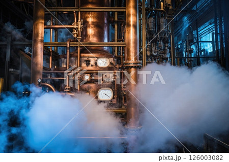 Industrial steam machines in atmospheric factory setting with vintage copper pipes and dials Industrial steam machines in atmospheric factory setting with vintage copper pipes and dials 126003082