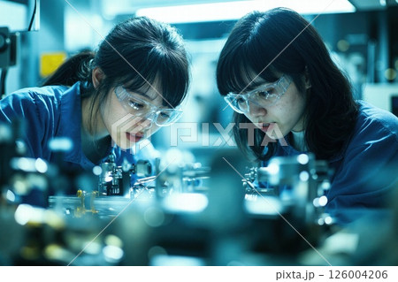 Collaborative female scientists in laboratory setting with cutting-edge technology and focus on innovation 126004206