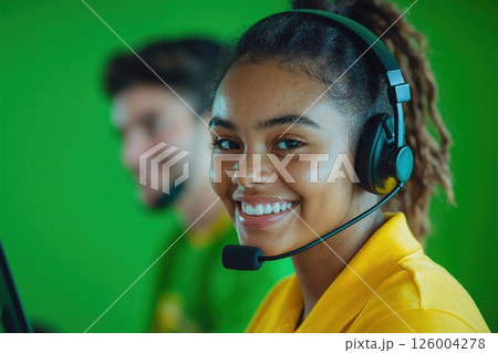 Customer service support team with headsets on green background for professional helpdesk solutions Customer service support team with headsets on green background for professional helpdesk solutions 126004278