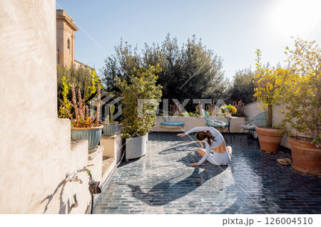 Morning Stretch on a Rooftop Terrace in Southern Italy Morning Stretch on a Rooftop Terrace in Southern Italy 126004510