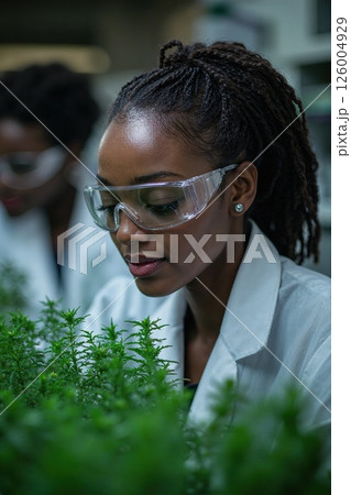 Innovative women in scientific research analyzing herbal plants in modern laboratory for sustainable medicine development Innovative women in scientific research analyzing herbal plants in modern laboratory for sustainable medicine development 126004929