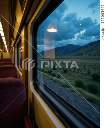 Scenic train journey at dusk through serene countryside landscapes under cloudy skies Scenic train journey at dusk through serene countryside landscapes under cloudy skies 126005491