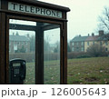 Vintage telephone booth in misty urban park reflecting nostalgia and seasonal atmosphere 126005643