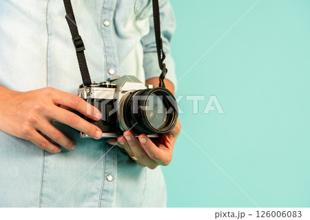 Photographer woman holding old vintage camera 126006083