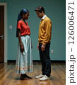 Introspective moment between two individuals in vibrant attire reflecting interpersonal dynamics 126006471