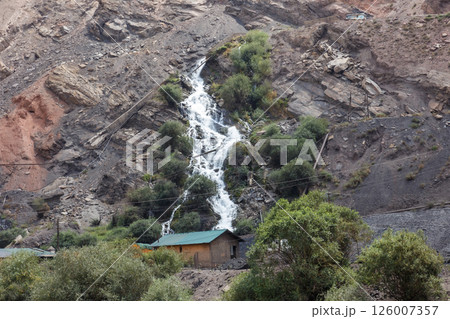 Dramatic waterfall cascades down rocky mountain side in Tajikistan Dramatic waterfall cascades down rocky mountain side in Tajikistan 126007357