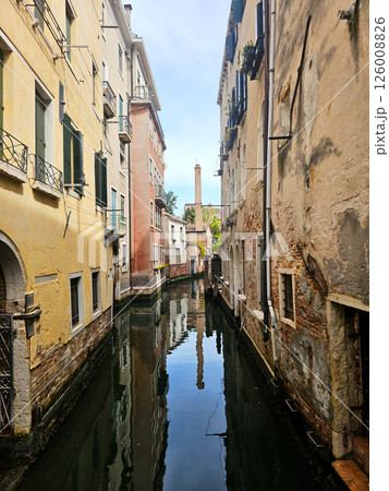 Picturesque view of a Venice canal taken from a bridge. Historic buildings with colorful facades Picturesque view of a Venice canal taken from a bridge. Historic buildings with colorful facades 126008826