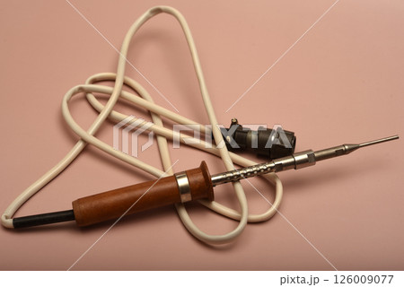 An old soldering iron with a silver tip. An old soldering iron with a silver tip. 126009077