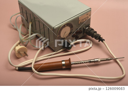 Retro soldering station. An old soldering iron with a silver tip. Retro soldering station. An old soldering iron with a silver tip. 126009083