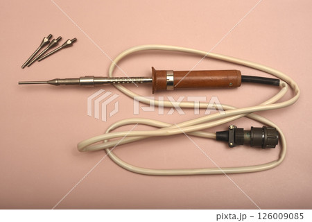 An old soldering iron with a silver tip. An old soldering iron with a silver tip. 126009085