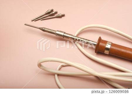 An old soldering iron with a silver tip. An old soldering iron with a silver tip. 126009086