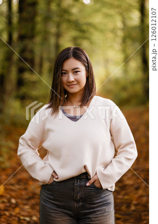 Young Woman Smiling in Autumn Forest Path Young Woman Smiling in Autumn Forest Path 126012107