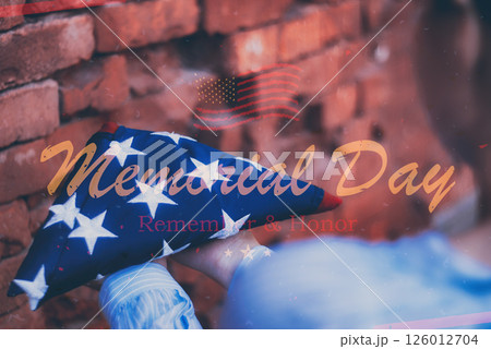 Woman holding folded american flag for Memorial Day tribute remember and honor veterans. Woman holding folded american flag for Memorial Day tribute remember and honor veterans. 126012704