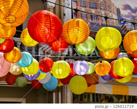 Multicolored Chinese lanterns hanging above the street. 126012719