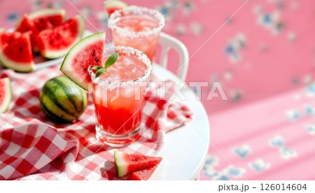 Two eye-catching watermelon margaritas with lime slices, a refreshing option for spring gatherings 126014604