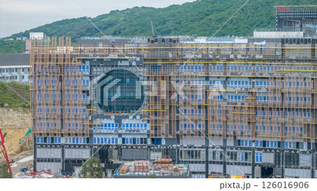 MAY 10 2025 Large Building Under Construction with Scaffolding and Mountain 126016906