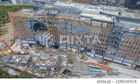 MAY 10 2025 View of a Large Urban Construction Site Amid Surrounding Greenery MAY 10 2025 View of a Large Urban Construction Site Amid Surrounding Greenery 126016918