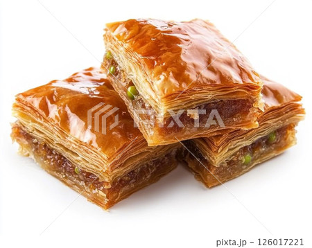 Baklava isolated on a white background. Baklava is a sweet pastry made of layers of filo dough filled with chopped nuts and sweetened with syrup or honey. 126017221