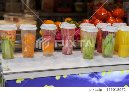 Colorful plastic cups filled with fresh fruits for juice or smoothies at a street food stall in Shanghai, China 126018672