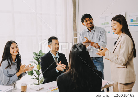 Team of financial advisory services. Asian advisor showing plan of investment to clients in the consultancy office. Team of financial advisory services. Asian advisor showing plan of investment to clients in the consultancy office. 126019465