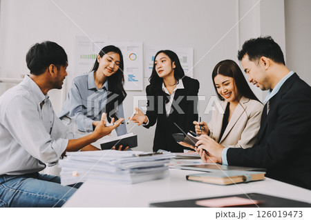 Team of financial advisory services. Asian advisor showing plan of investment to clients in the consultancy office. Team of financial advisory services. Asian advisor showing plan of investment to clients in the consultancy office. 126019473