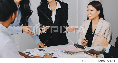 Team of financial advisory services. Asian advisor showing plan of investment to clients in the consultancy office. Team of financial advisory services. Asian advisor showing plan of investment to clients in the consultancy office. 126019474