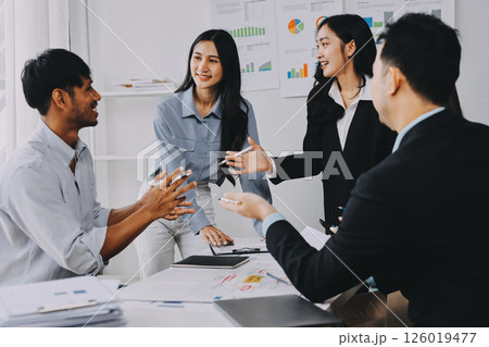 Team of financial advisory services. Asian advisor showing plan of investment to clients in the consultancy office. 126019477